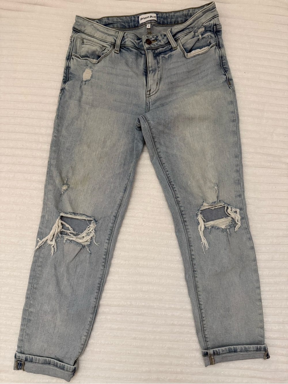 Studio Blue Light wash distressed jeans. Good condition, but coffee stain